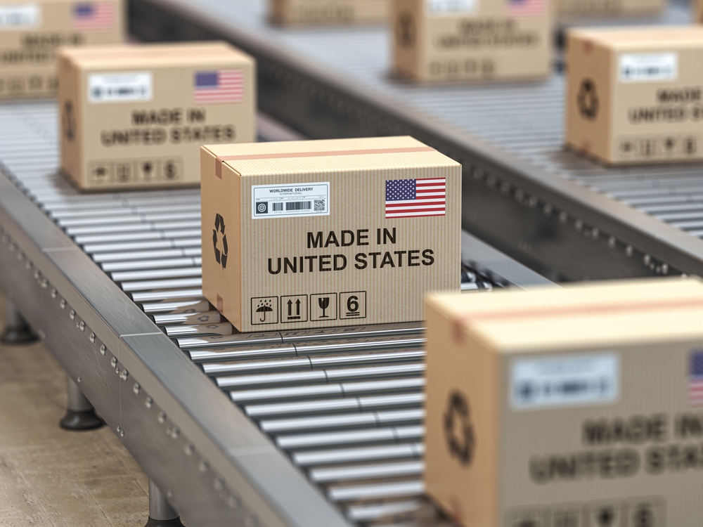Conveyor belt filled with boxes labeled “Made in United States”, representing the benefits of having domestic supply chain partners.